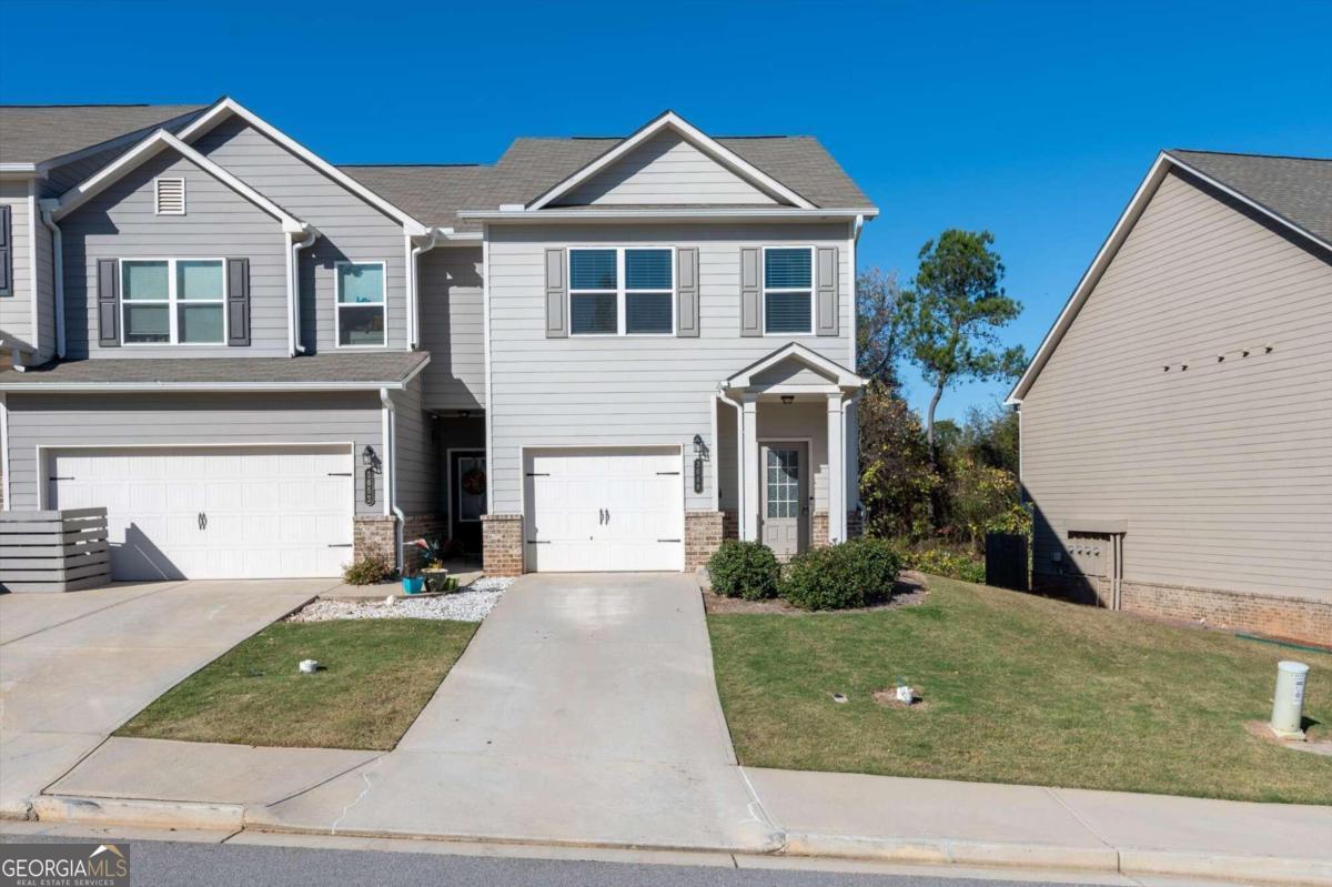 a front view of a house with a yard