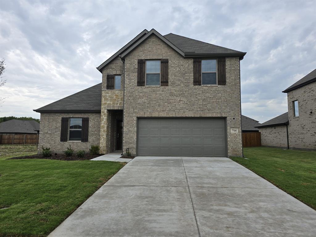 a front view of house with yard and green space