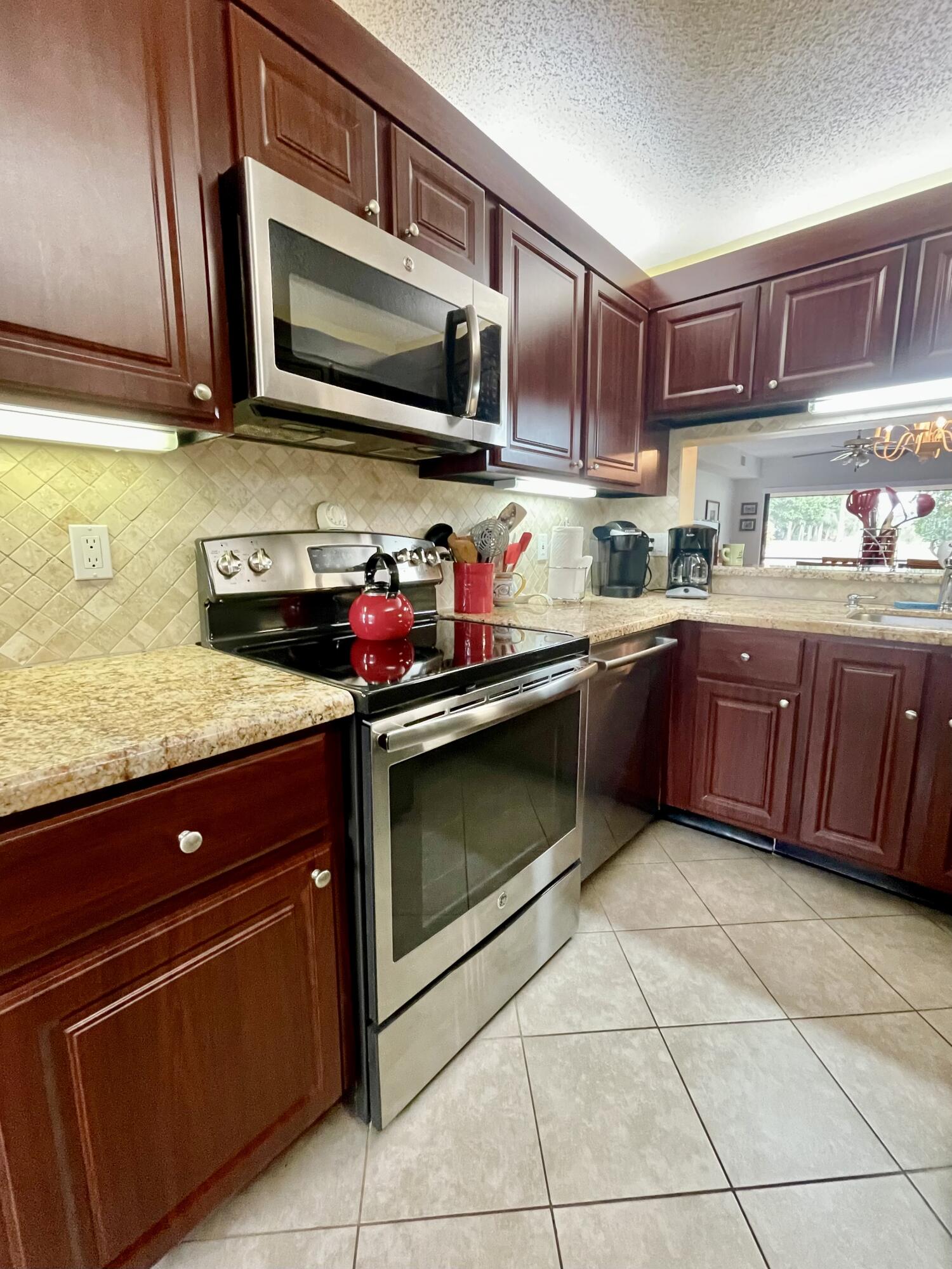 a kitchen with granite countertop stainless steel appliances and cabinets