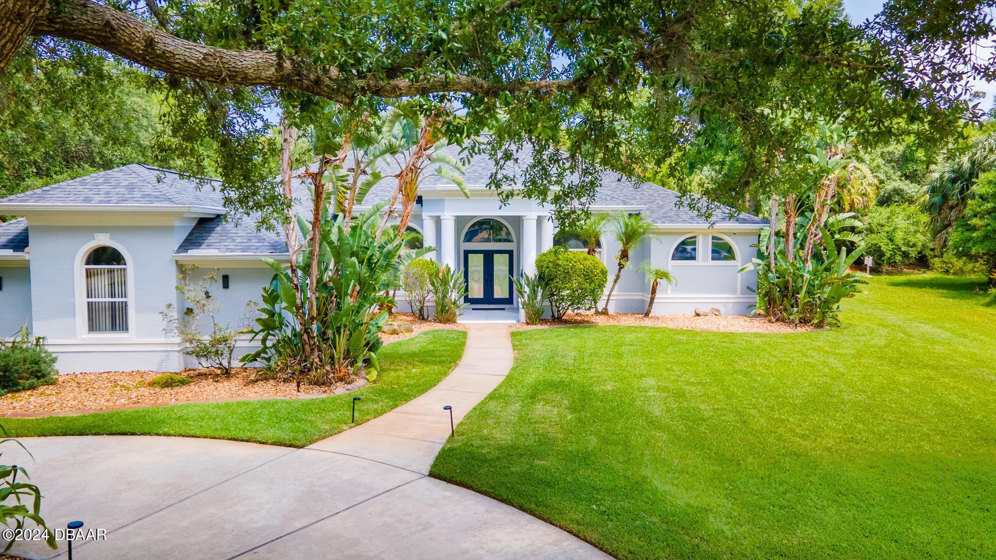 a front view of a house with garden