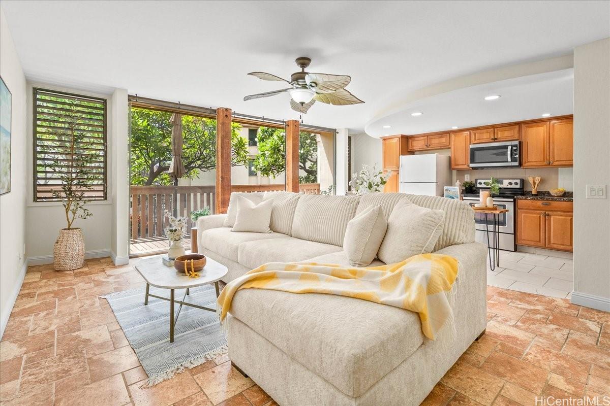 a living room with furniture a flat screen tv and a large window