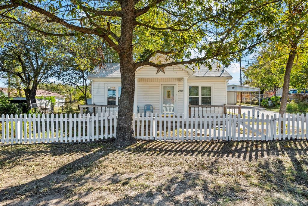 a front view of a house with a fence