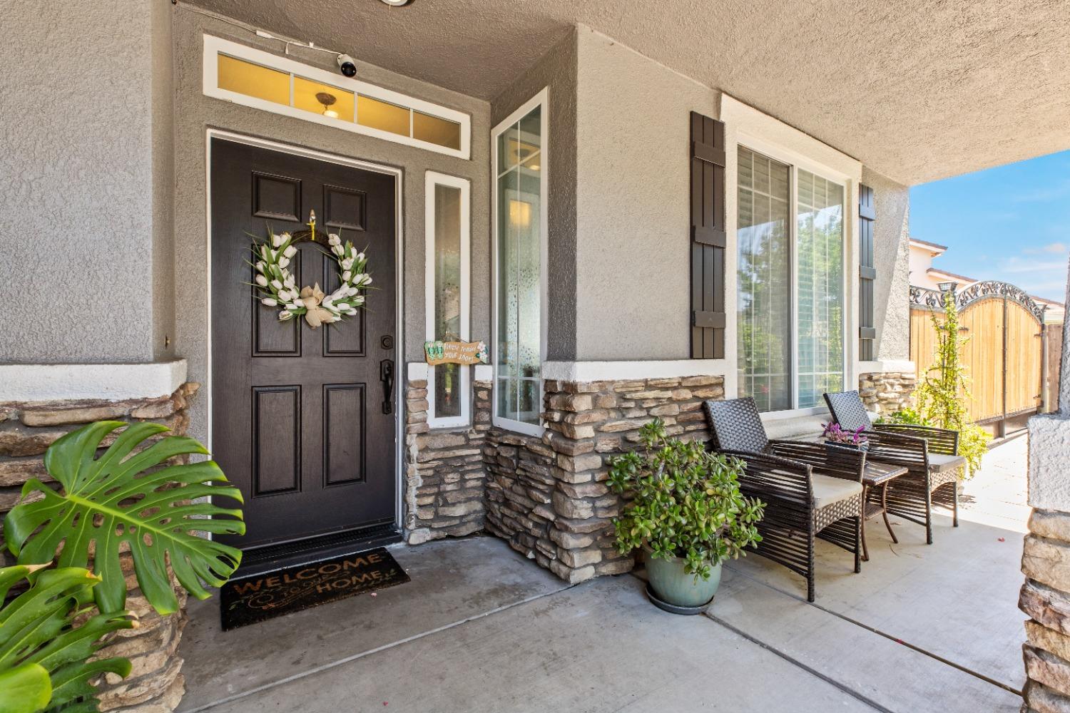 a view of front door of house with outdoor seating