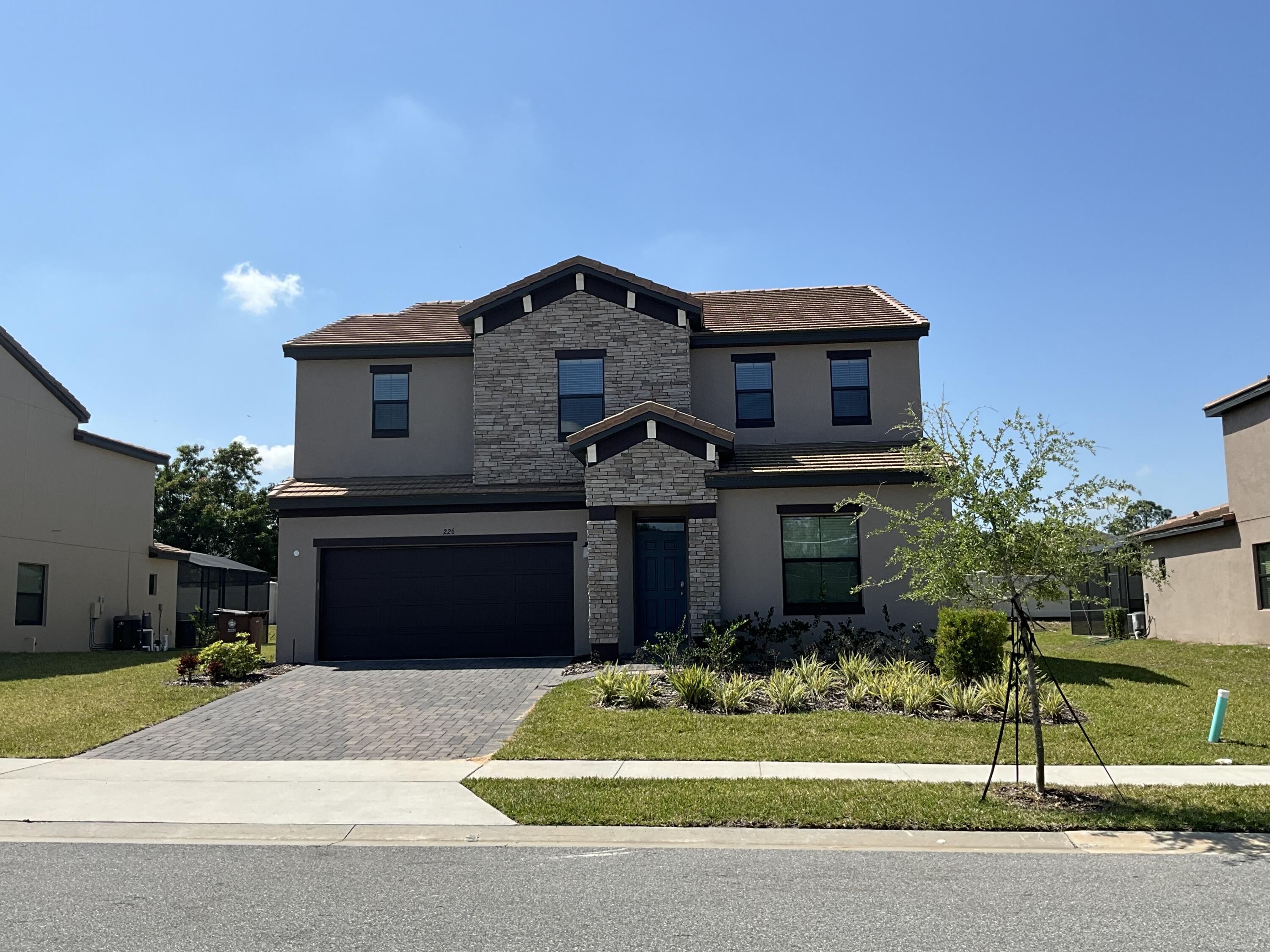 a front view of a house with a yard