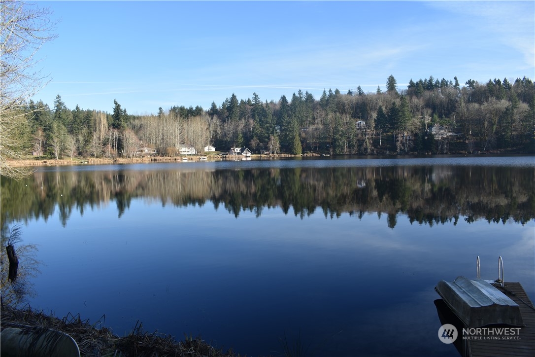 a view of a lake in between two and trees