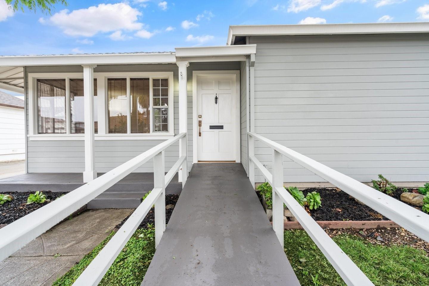 a view of a house with wooden fence