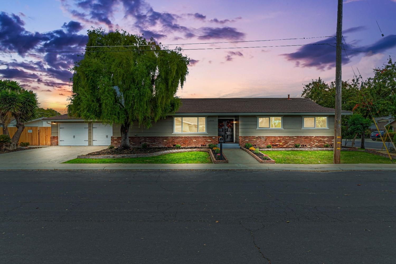 a front view of house with yard and green space