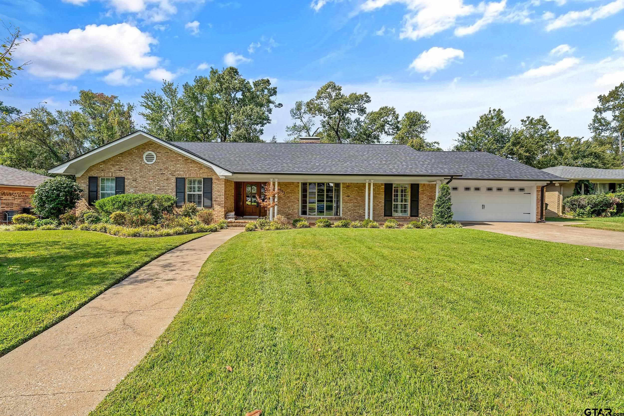 a front view of house with yard and green space