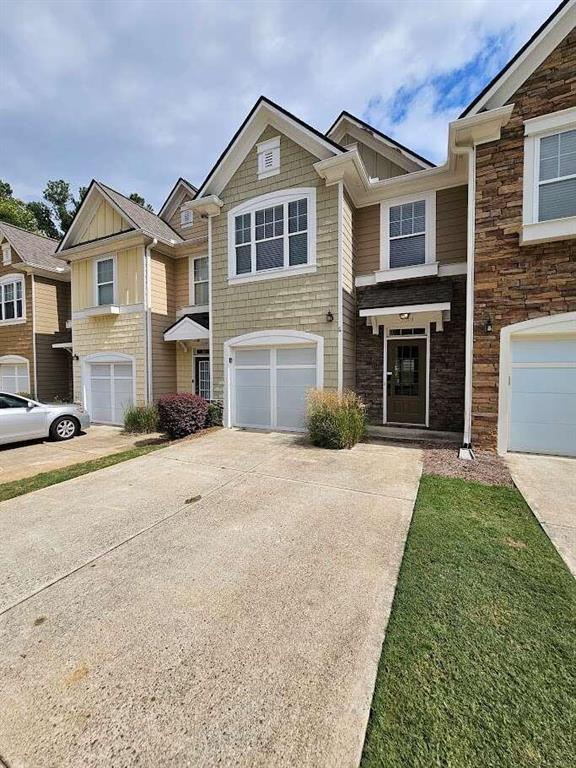 a front view of a house with a yard and garage