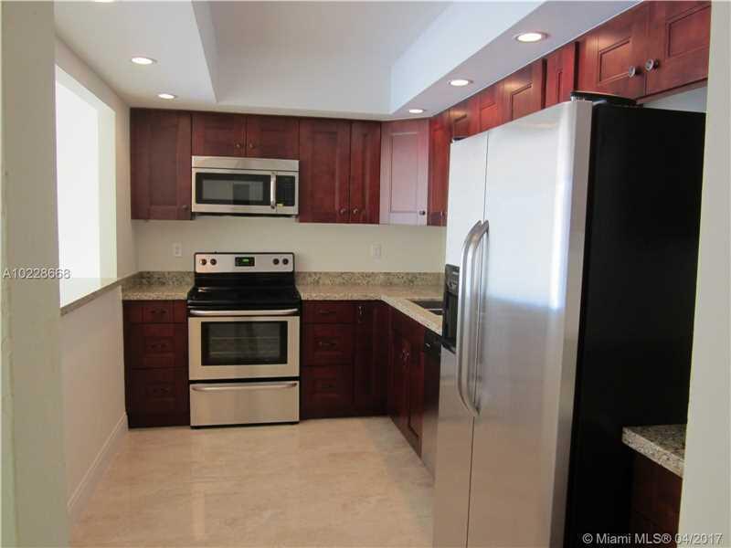 a kitchen with stainless steel appliances a refrigerator stove microwave and sink