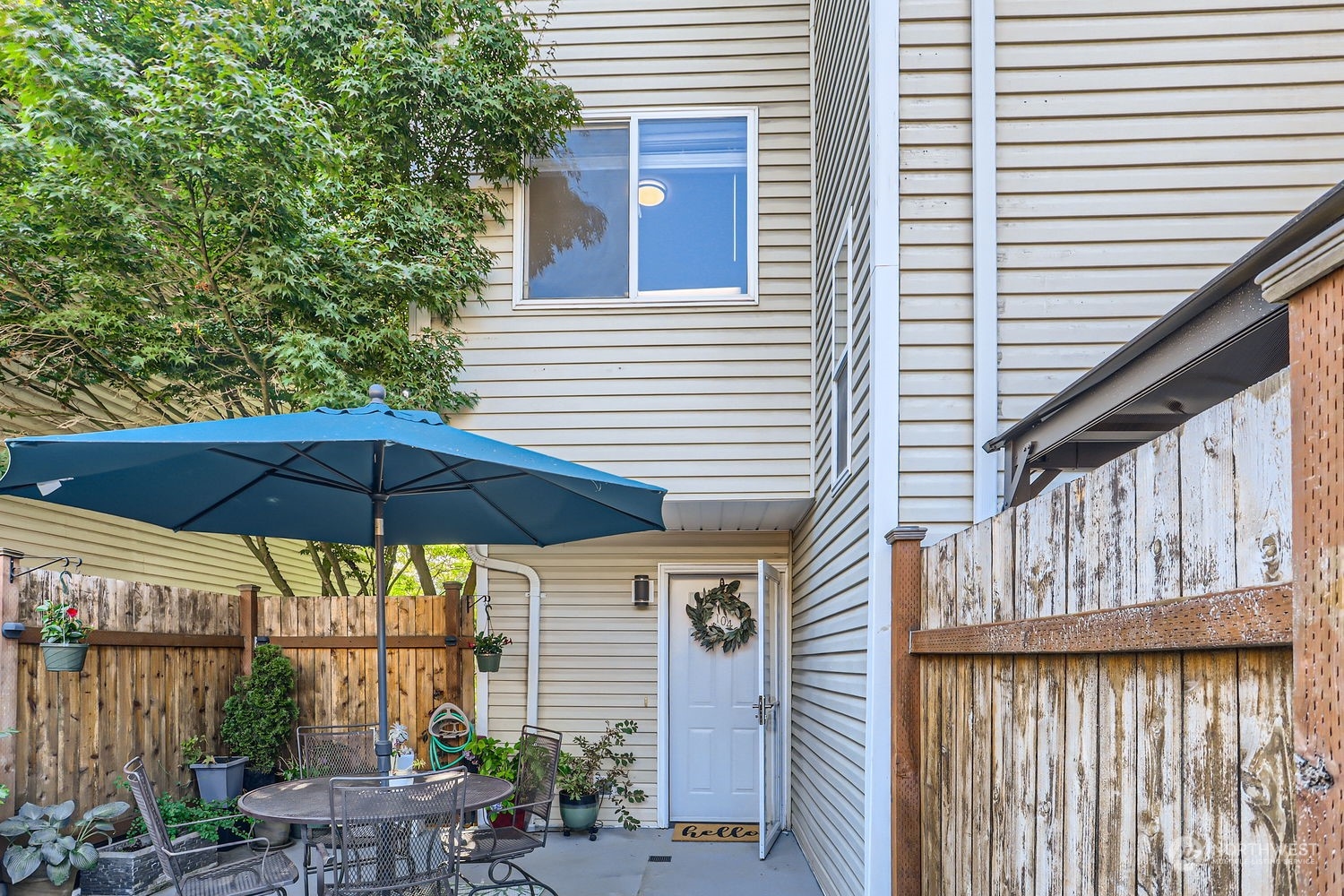 a blue and white umbrella sitting in front of a house