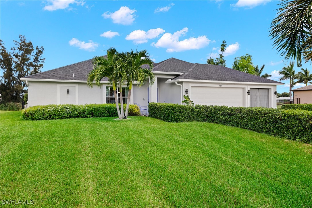 a front view of house with yard and green space