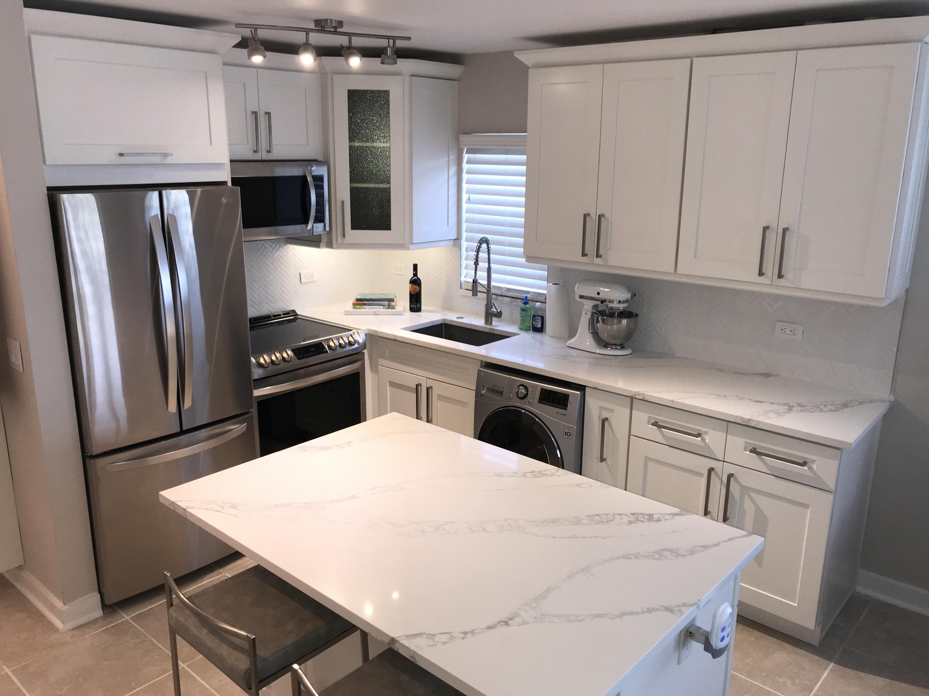 a kitchen with stainless steel appliances a stove refrigerator sink and cabinets