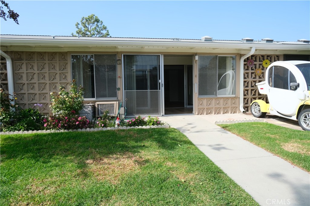 a view of a house with backyard porch and garden