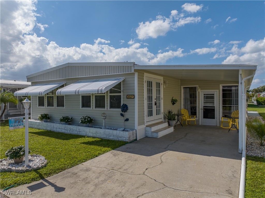 a front view of a house with swimming pool and porch with furniture