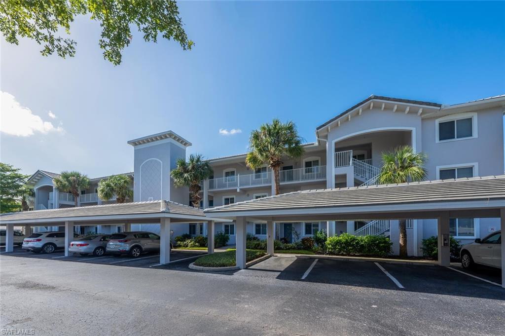 View of vehicle parking featuring a carport