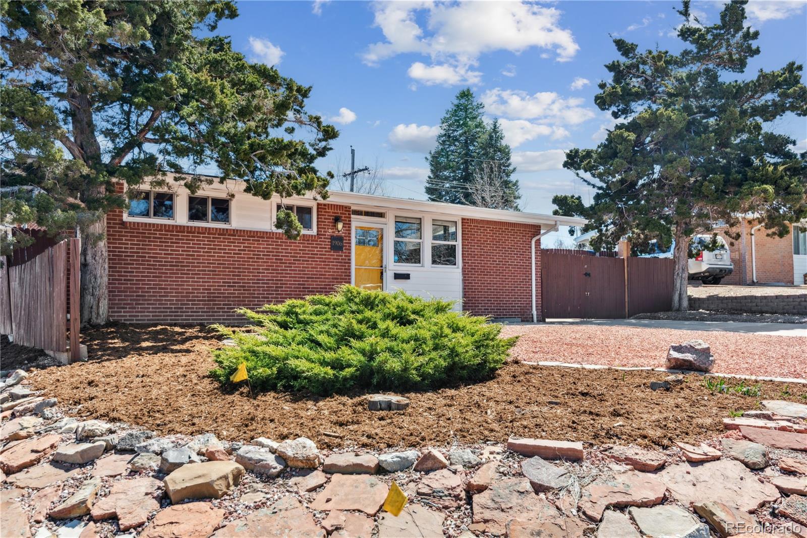 a front view of a house with garden