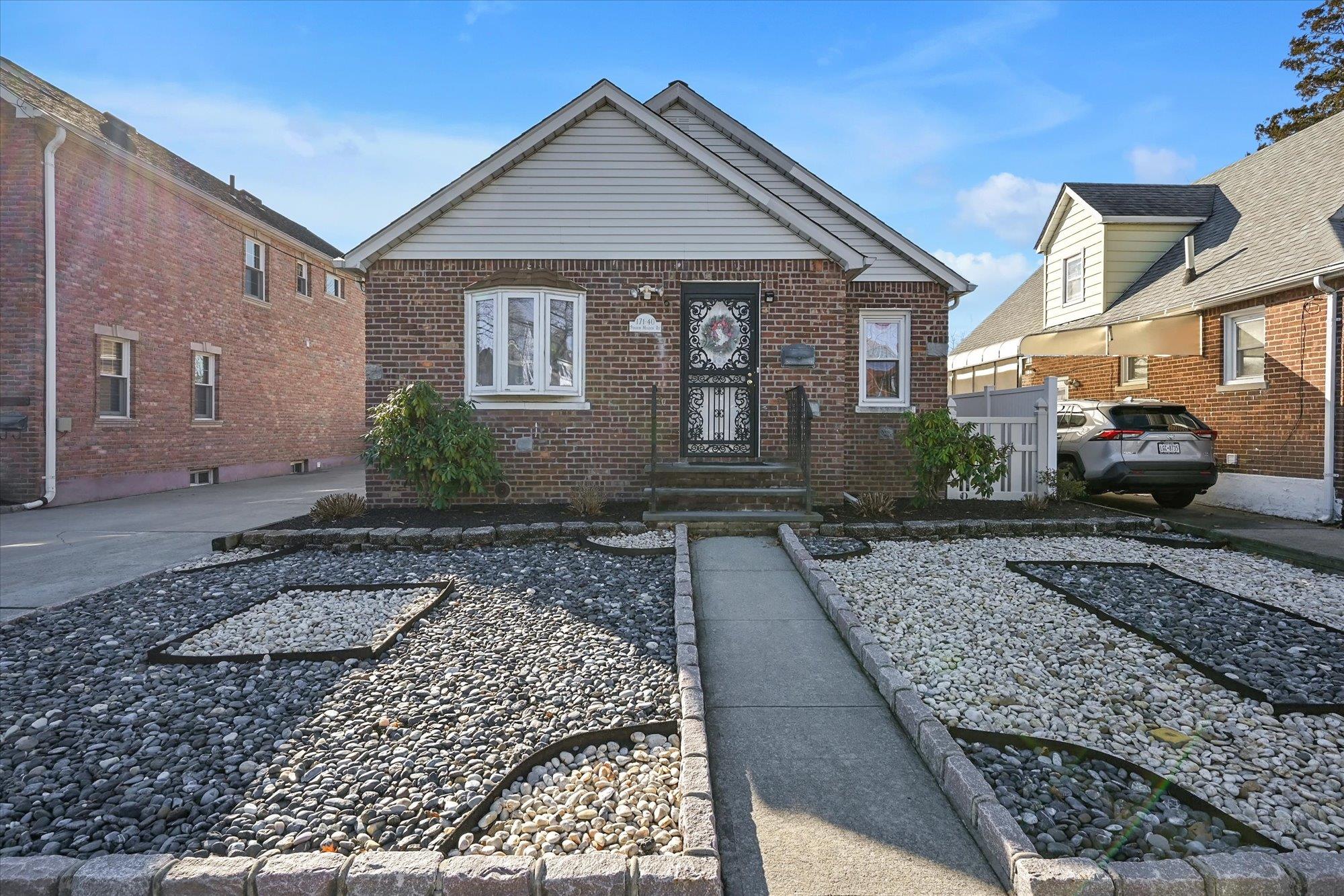 a front view of a house with garden