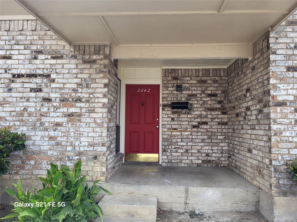 a view of front door of house with an outdoor space