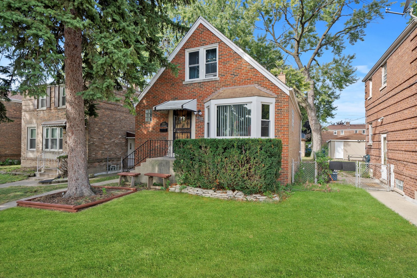 a front view of a house with a garden