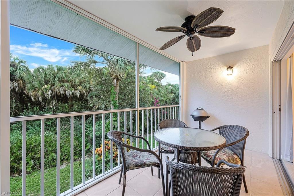 a view of a balcony with a table and a chairs