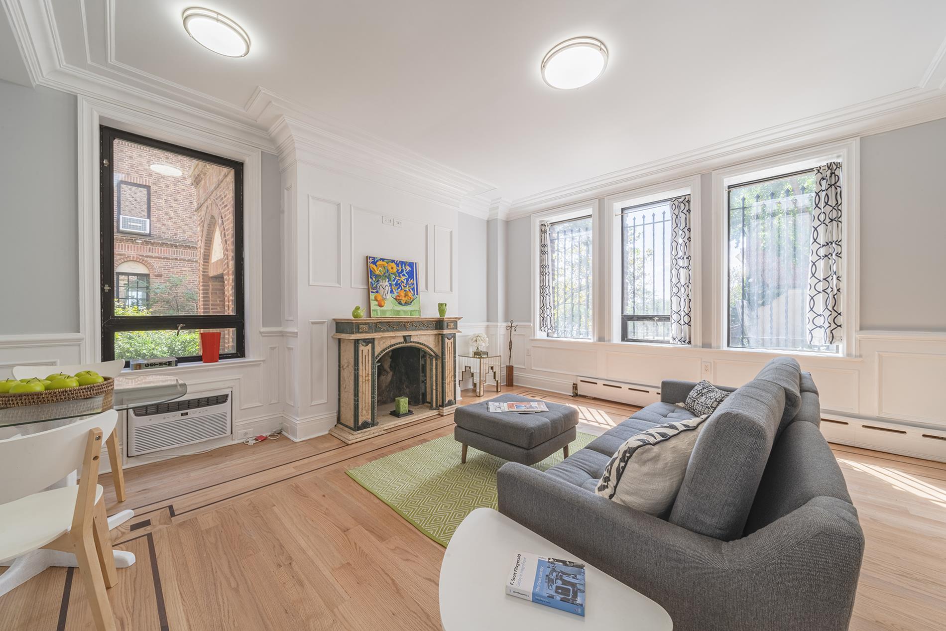 a living room with furniture a large window and a fireplace