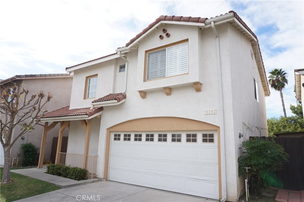 a view of a house with a yard and garage