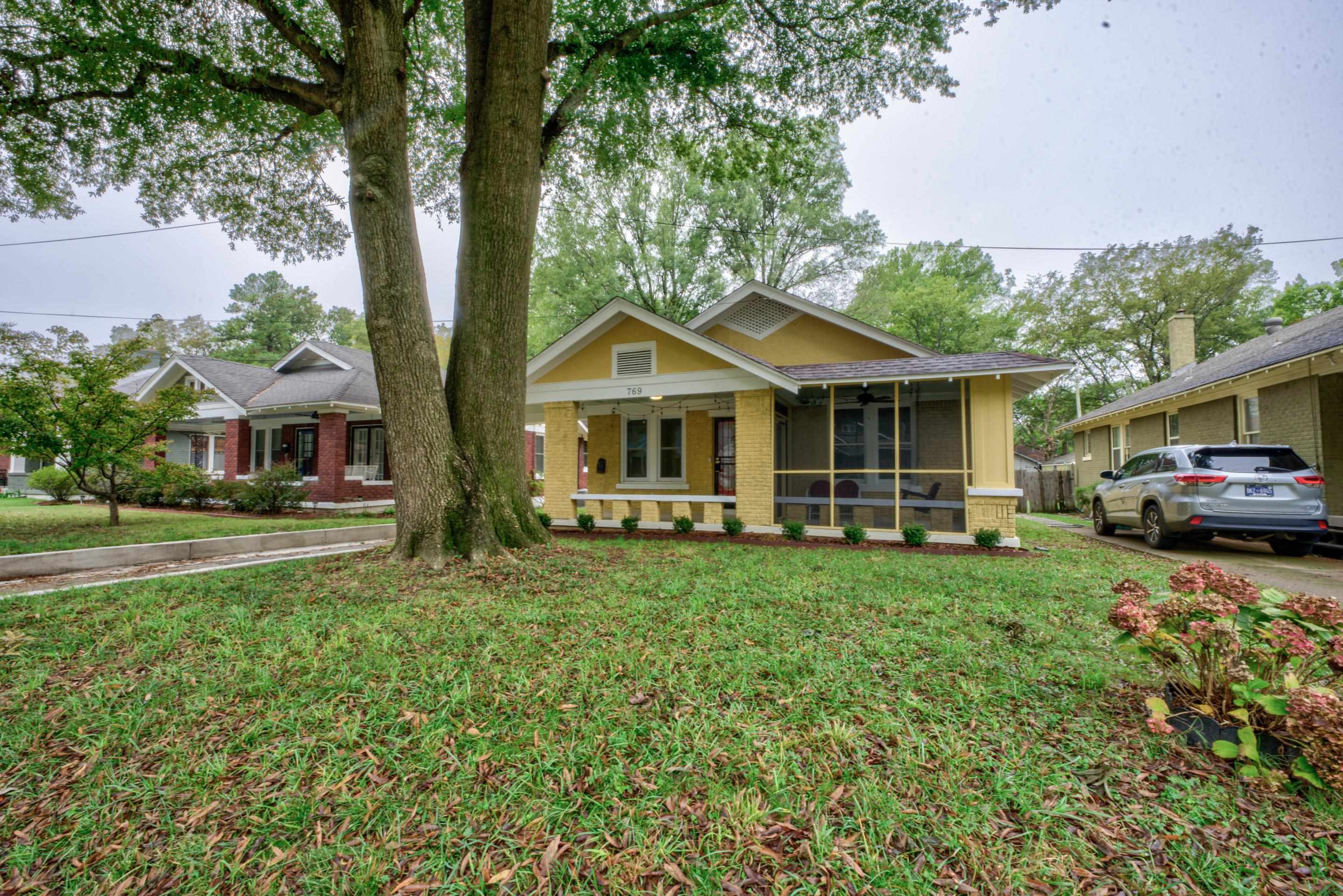 View of front of house featuring a front yard and a sunroom