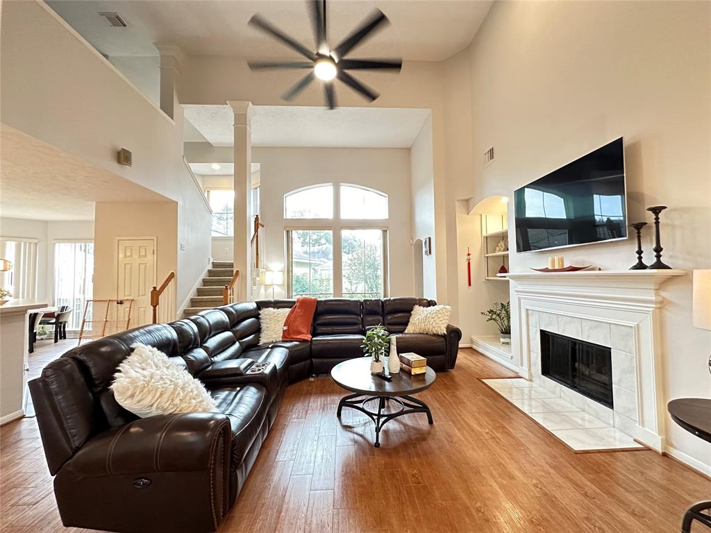 a living room with furniture fireplace and flat screen tv