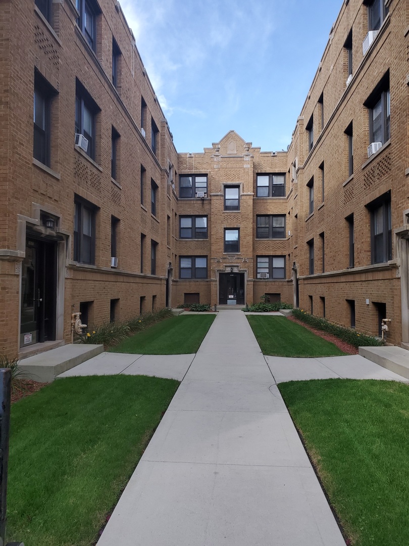 a front view of a building with a yard