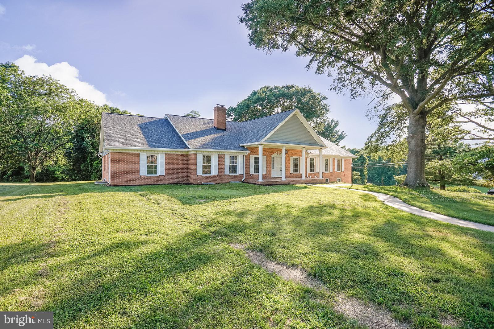 a front view of house with yard and green space