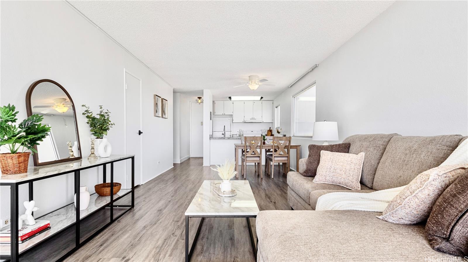 a living room with furniture and wooden floor