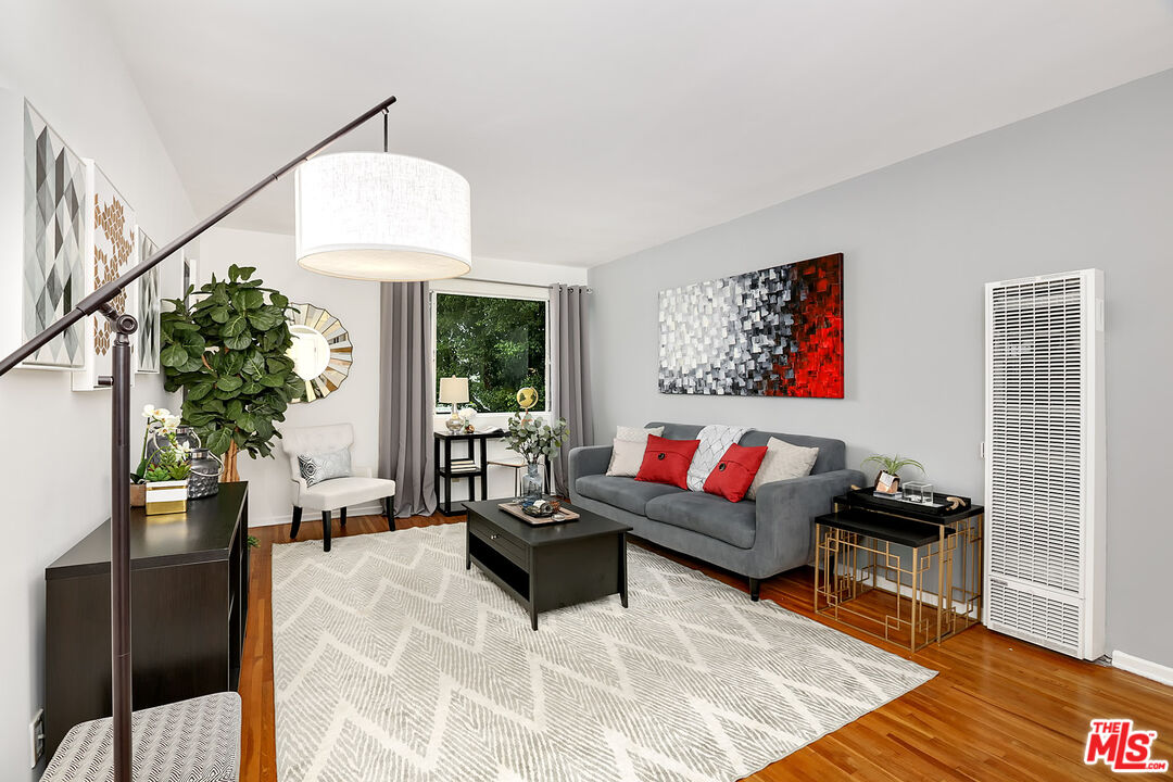 a living room with furniture and a potted plant