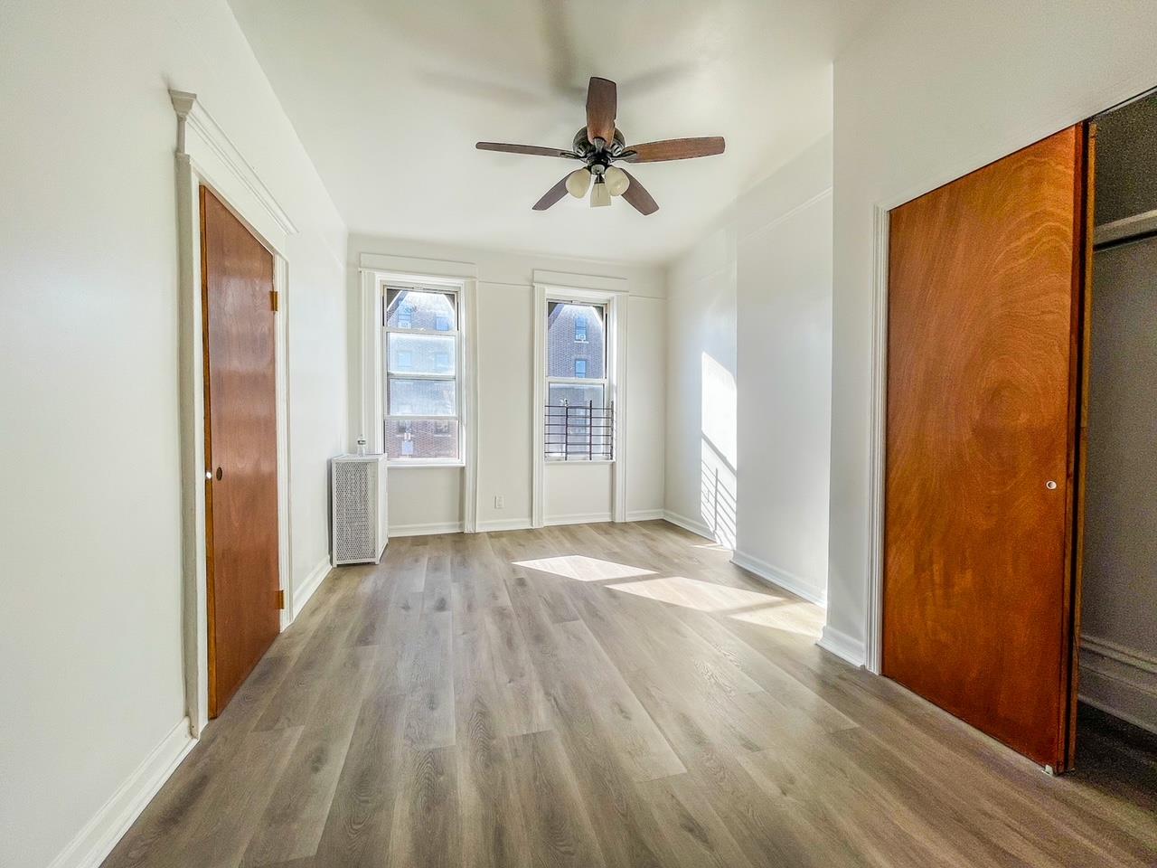 wooden floor in an empty room with a window