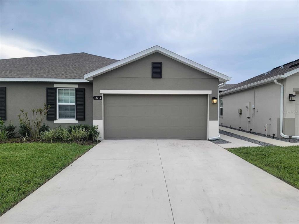 a front view of house with a yard and garage