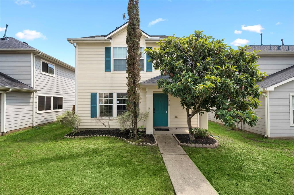 a view of a house with a yard