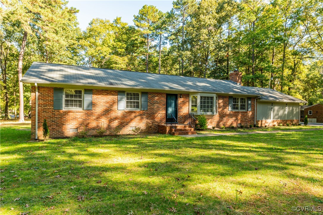 a view of a house with a big yard and large trees