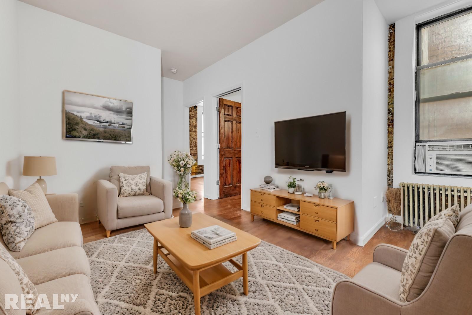 a living room with furniture and a flat screen tv