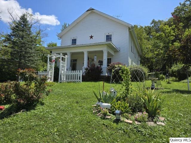 a front view of house with garden