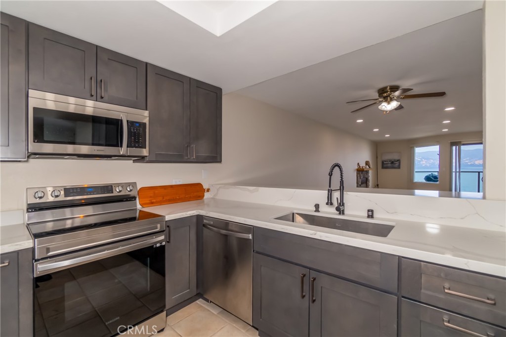 a kitchen with a sink stainless steel appliances and cabinets