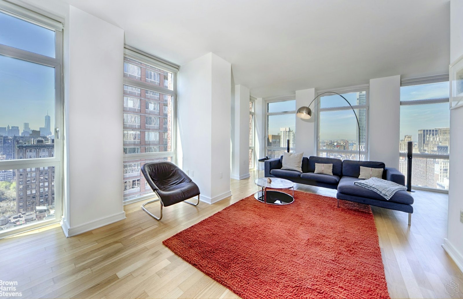 a living room with furniture rug and wooden floor