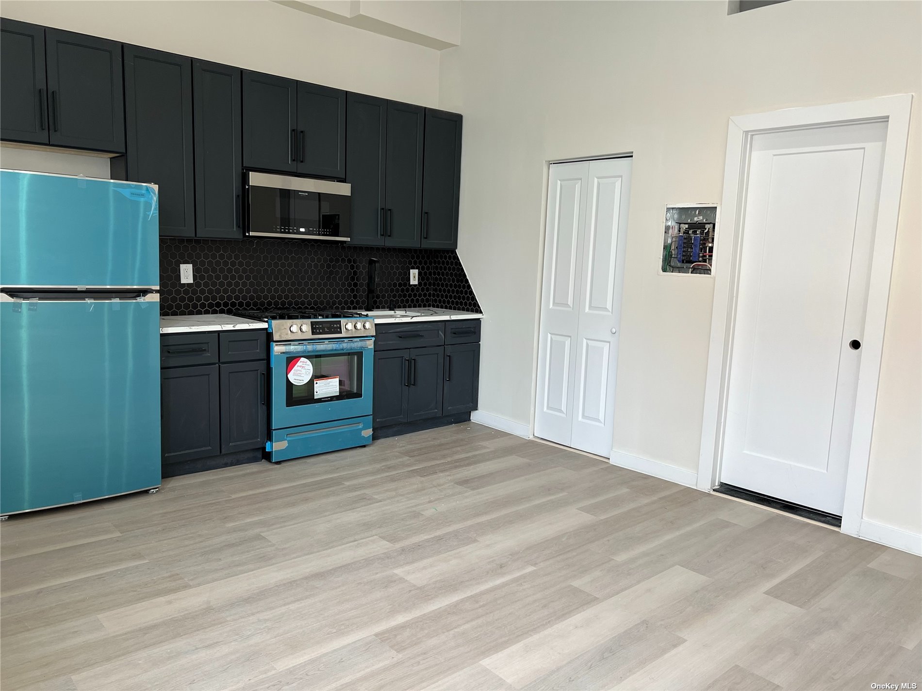 a kitchen with a stove and a refrigerator