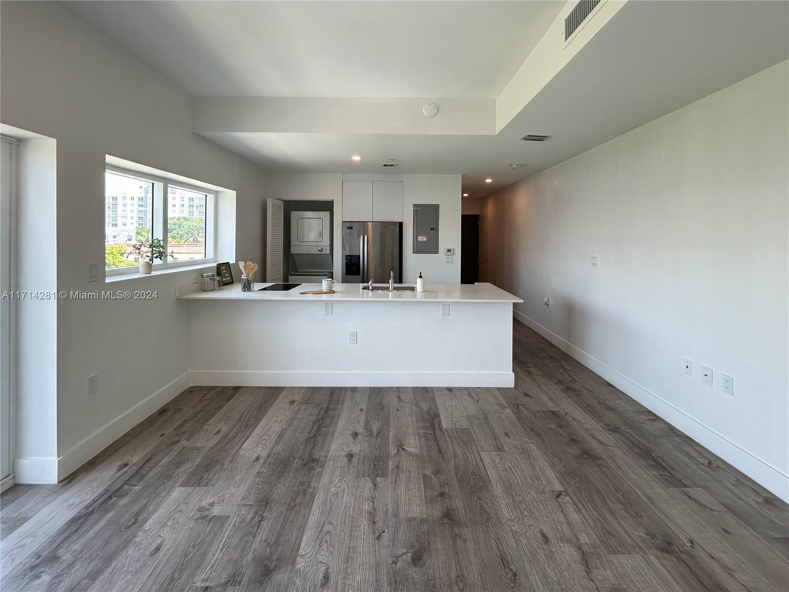 a view of kitchen with wooden floor and window