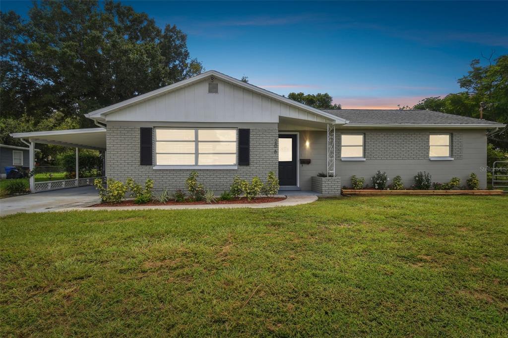 a front view of house with yard and green space