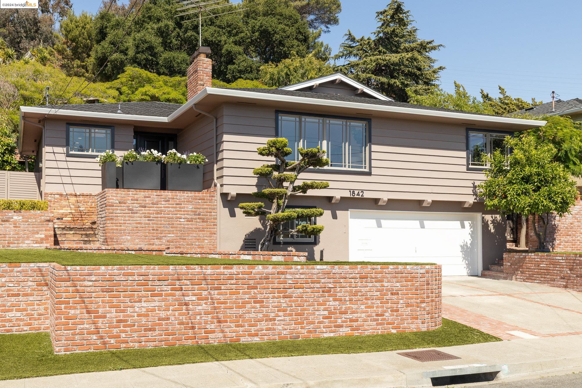 a front view of a house with garden