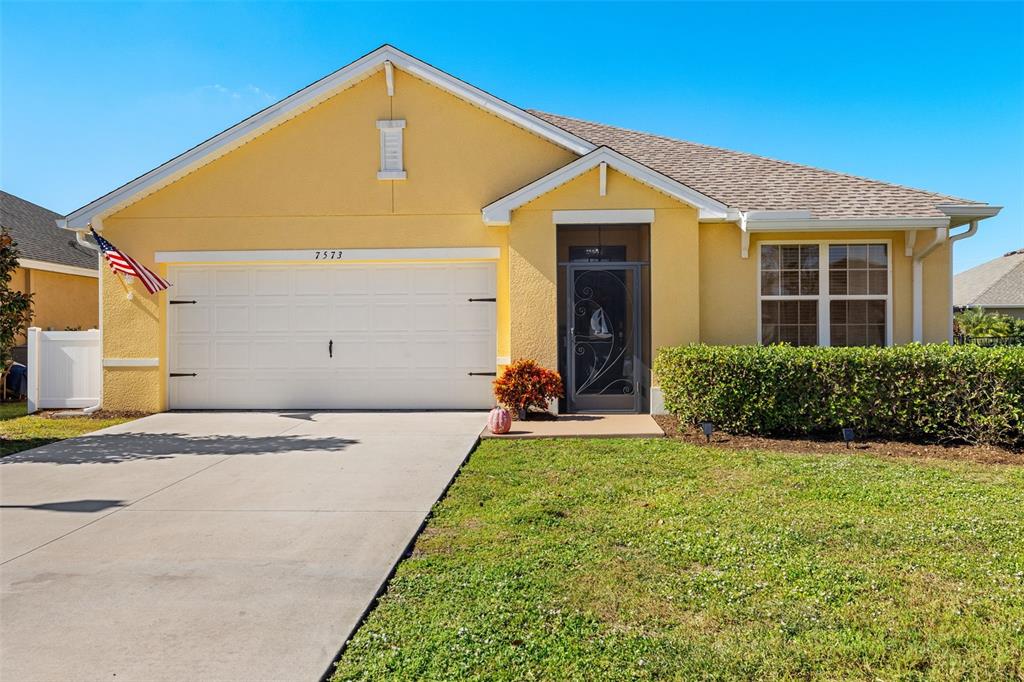 a view of a house with backyard and garage