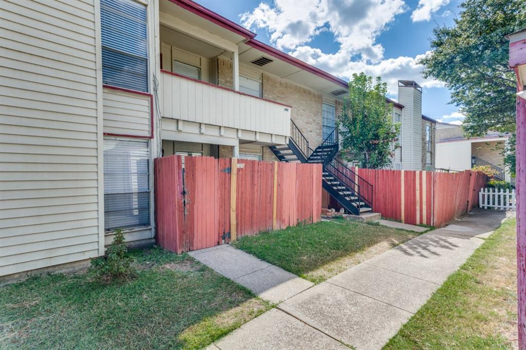 a view of a backyard with wooden fence