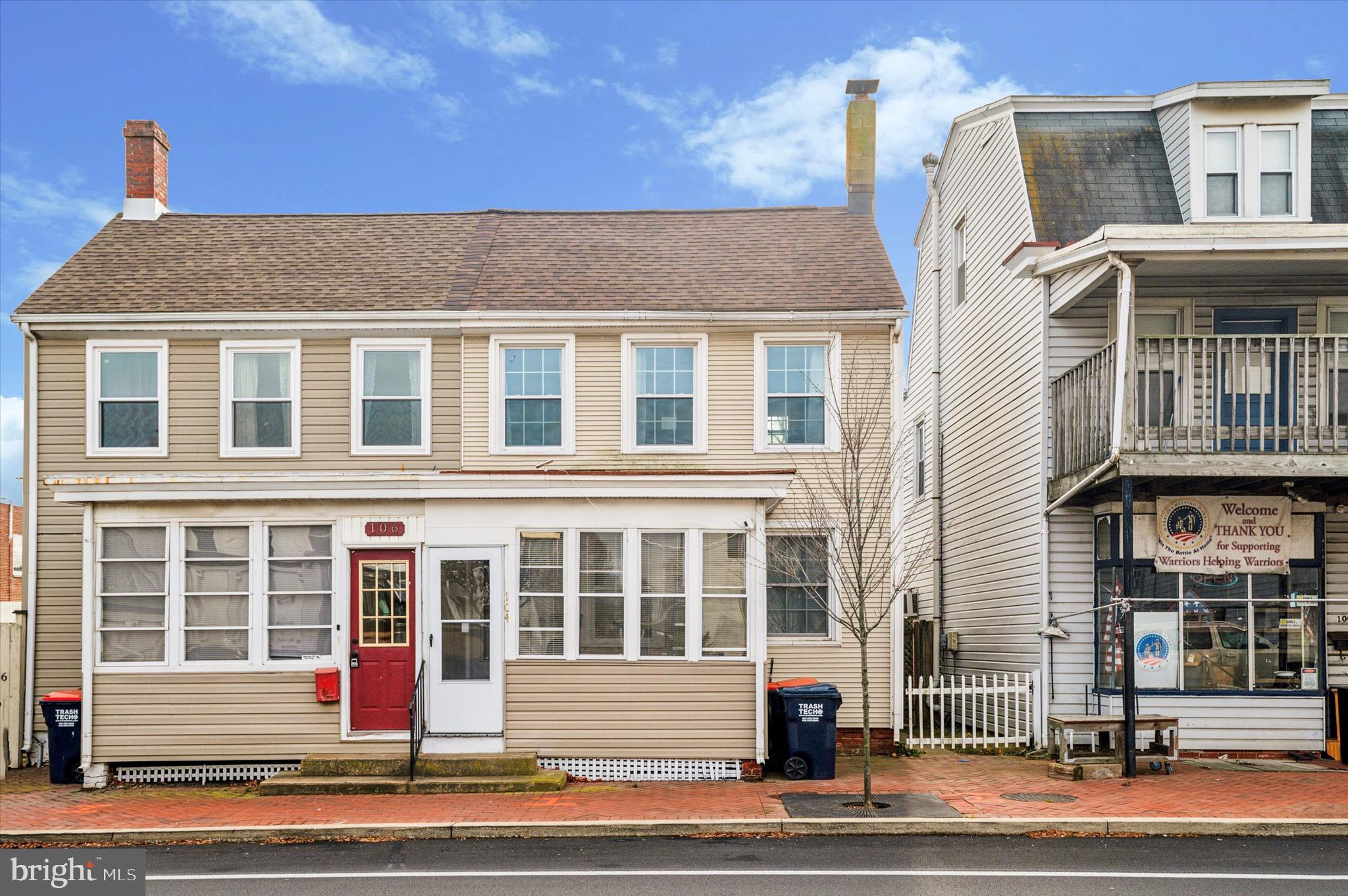 a front view of a residential apartment building with a yard