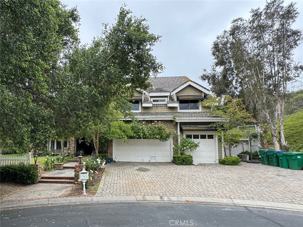 a front view of a house with a yard garage and outdoor seating