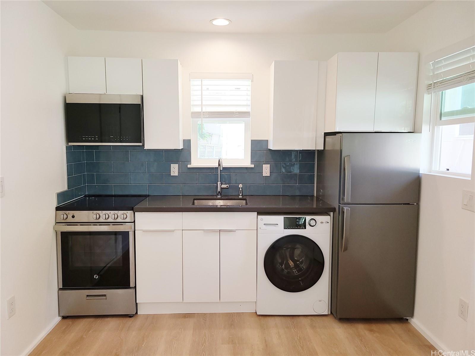 a kitchen with a stove a washer and dryer